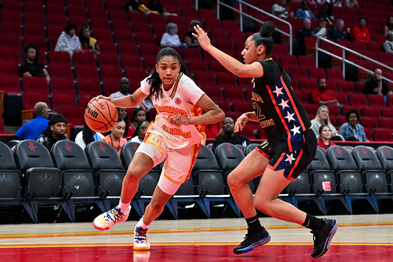 McDonald's All American East forward Riley Nelson (4) drives around McDonald's All American West guard JuJu Watkins (12) during the first half at Toyota Center.